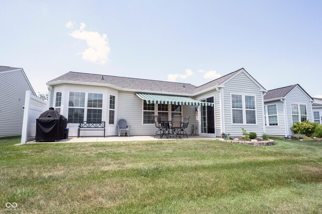 12985 Merlot Ln, Fishers, IN 46037 - back of house featuring a patio area, a lawn, and roof with shingles