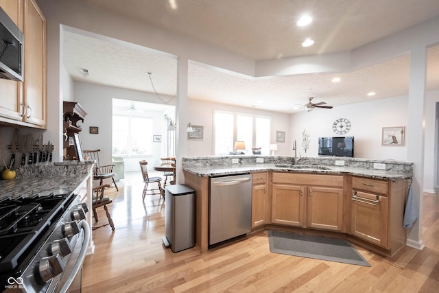 12985 Merlot Ln, Fishers, IN 46037 - kitchen with appliances with stainless steel finishes, ceiling fan, light wood-style flooring, light stone counters, and recessed lighting