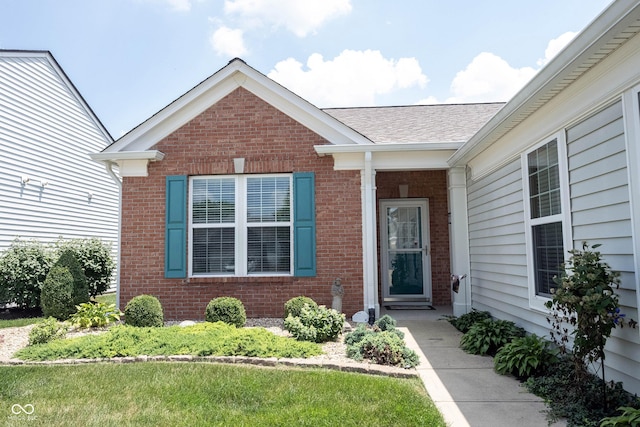 12985 Merlot Ln, Fishers, IN 46037 - view of exterior entry featuring brick siding and roof with shingles