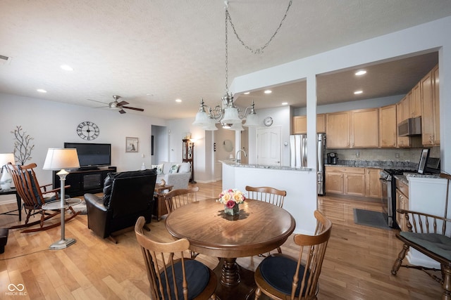 12985 Merlot Ln, Fishers, IN 46037 - dining room featuring light wood-style floors, ceiling fan, and recessed lighting