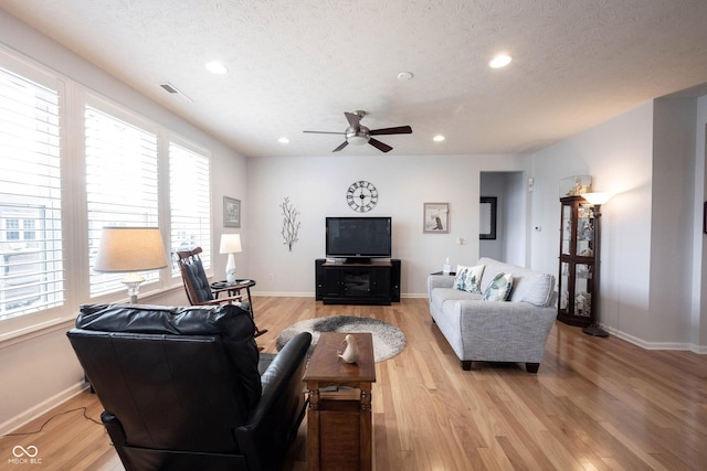 12985 Merlot Ln, Fishers, IN 46037 - living room with ceiling fan, a textured ceiling, light wood finished floors, healthy amount of natural light, and recessed lighting