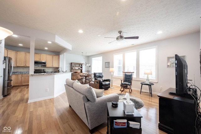 12985 Merlot Ln, Fishers, IN 46037 - living room featuring ceiling fan, light wood-style floors, recessed lighting, and a textured ceiling