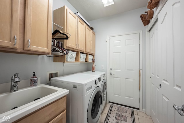 12985 Merlot Ln, Fishers, IN 46037 - washroom featuring cabinet space, washer and dryer, and light tile patterned floors