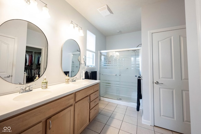 12985 Merlot Ln, Fishers, IN 46037 - full bath featuring a shower stall, tile patterned flooring, double vanity, and a walk in closet