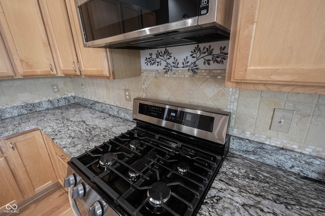 12985 Merlot Ln, Fishers, IN 46037 - kitchen featuring stainless steel appliances, light stone counters, tasteful backsplash, and light brown cabinetry
