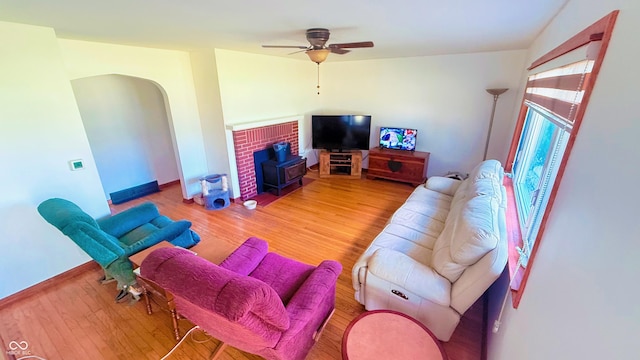 5964 E 250 N, Greenfield, IN 46140 - living area with wood finished floors, a ceiling fan, a wood stove, and arched walkways