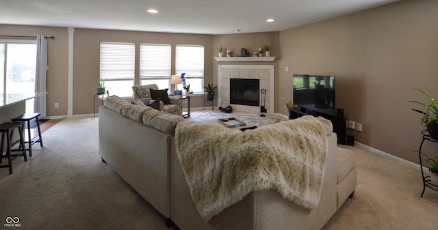 14521 Stewart Cir, Fishers, IN 46038 - living area with light colored carpet, a tiled fireplace, plenty of natural light, and recessed lighting