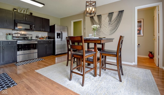 14521 Stewart Cir, Fishers, IN 46038 - dining space with light wood-style flooring and a chandelier