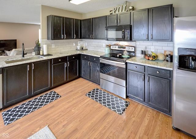 14521 Stewart Cir, Fishers, IN 46038 - kitchen featuring appliances with stainless steel finishes, light wood-style flooring, and tasteful backsplash