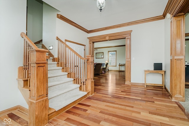 7178 Lockford Walk N, Avon, IN 46123 - entryway with crown molding, light wood finished floors, and stairs