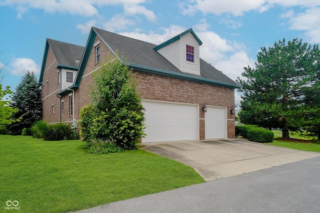 7178 Lockford Walk N, Avon, IN 46123 - view of side of home with brick siding, concrete driveway, a yard, an attached garage, and roof with shingles