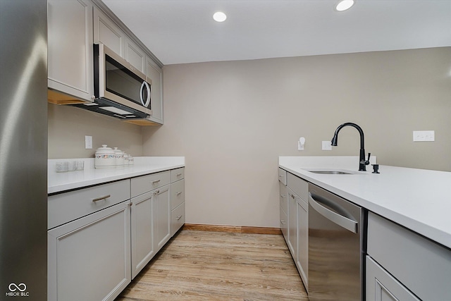 7178 Lockford Walk N, Avon, IN 46123 - kitchen featuring appliances with stainless steel finishes, gray cabinets, light wood-style floors, recessed lighting, and light countertops