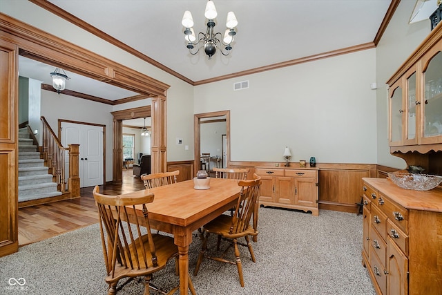 7178 Lockford Walk N, Avon, IN 46123 - dining room with a wainscoted wall, stairway, crown molding, light colored carpet, and a chandelier
