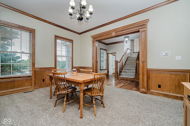 7178 Lockford Walk N, Avon, IN 46123 - dining room featuring wainscoting, a chandelier, light wood-style floors, stairs, and crown molding