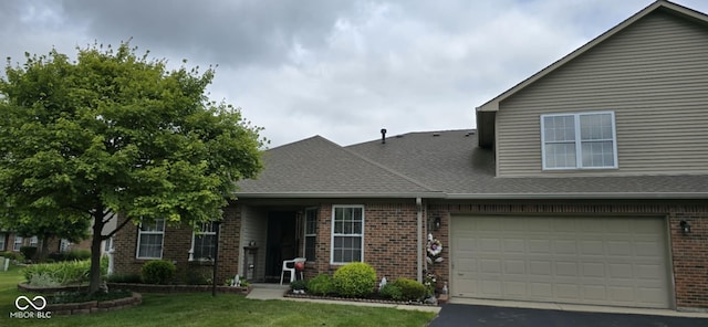 5333 Thornridge Pl, Indianapolis, IN 46237 - view of front of house featuring brick siding, a front yard, roof with shingles, driveway, and an attached garage