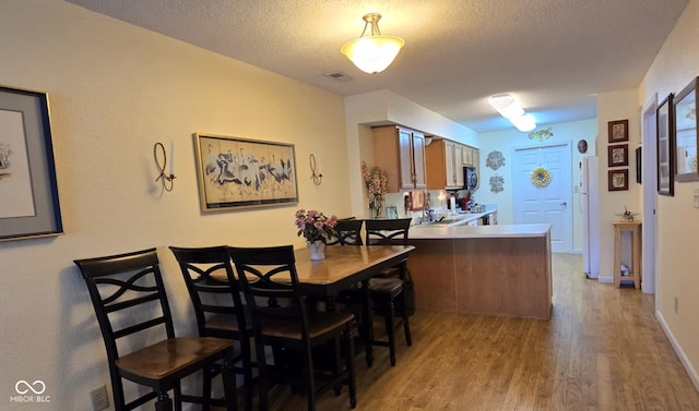 5333 Thornridge Pl, Indianapolis, IN 46237 - dining room featuring light wood finished floors and a textured ceiling