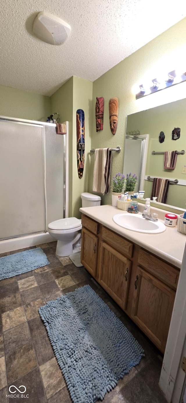 5333 Thornridge Pl, Indianapolis, IN 46237 - bathroom with vanity, a stall shower, a textured ceiling, and stone finish floors