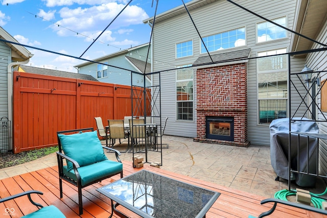 4219 Trilithon Ct, West Lafayette, IN 47906 - wooden terrace featuring grilling area, outdoor dining space, a patio area, and an outdoor living space with a fireplace