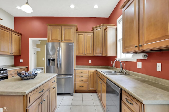 4219 Trilithon Ct, West Lafayette, IN 47906 - kitchen featuring stainless steel appliances, light countertops, light tile patterned floors, a center island, and brown cabinetry