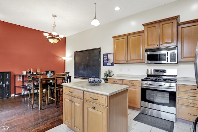 4219 Trilithon Ct, West Lafayette, IN 47906 - kitchen with appliances with stainless steel finishes, light countertops, a chandelier, decorative light fixtures, and a center island