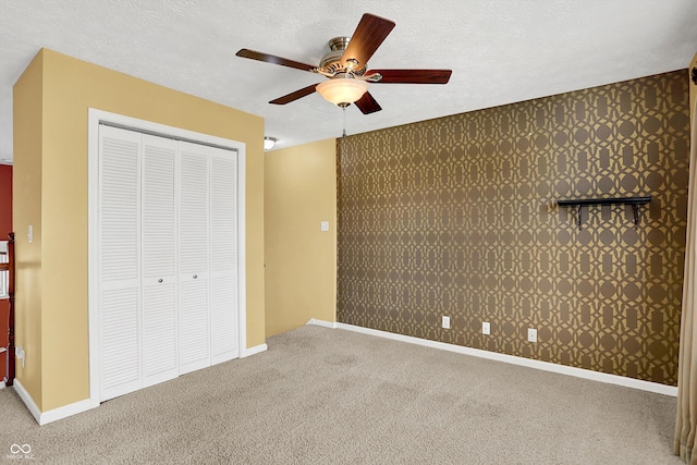 4219 Trilithon Ct, West Lafayette, IN 47906 - unfurnished bedroom featuring carpet floors, a closet, a ceiling fan, a textured ceiling, and wallpapered walls