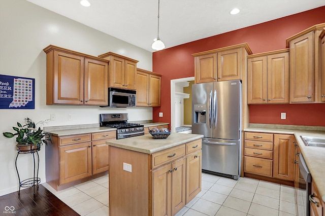 4219 Trilithon Ct, West Lafayette, IN 47906 - kitchen with stainless steel appliances, a center island, light countertops, decorative light fixtures, and light tile patterned floors