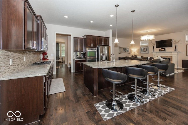 15540 Provincial Ln, Fishers, IN 46040 - kitchen with appliances with stainless steel finishes, open floor plan, dark brown cabinets, backsplash, and recessed lighting