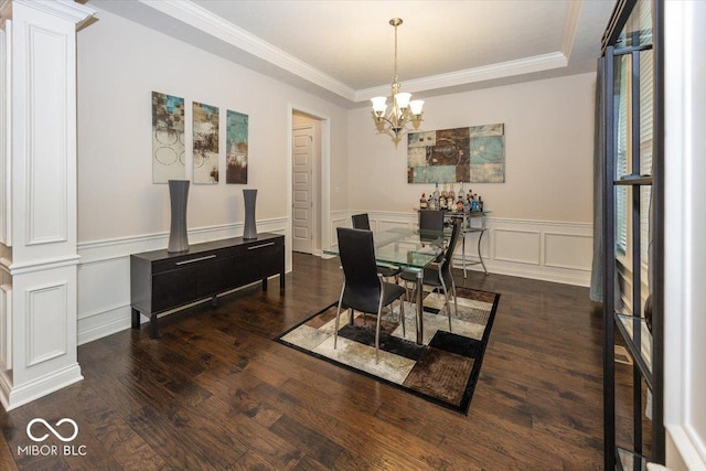 15540 Provincial Ln, Fishers, IN 46040 - dining space with ornate columns, wood finished floors, a chandelier, crown molding, and a wainscoted wall