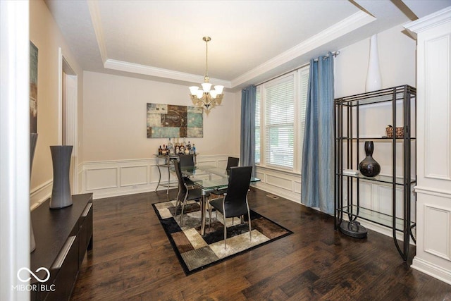 15540 Provincial Ln, Fishers, IN 46040 - dining area featuring a raised ceiling, a chandelier, wood finished floors, crown molding, and a decorative wall