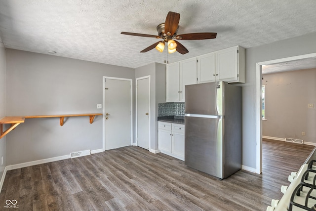 1108 Warwick Dr, New Whiteland, IN 46184 - kitchen featuring freestanding refrigerator, ceiling fan, dark wood-type flooring, a textured ceiling, and white cabinets