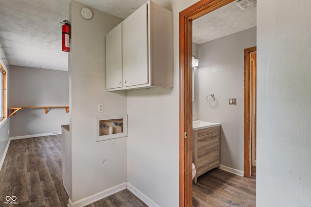 1108 Warwick Dr, New Whiteland, IN 46184 - laundry room with hookup for a washing machine, dark wood finished floors, cabinet space, and a textured ceiling