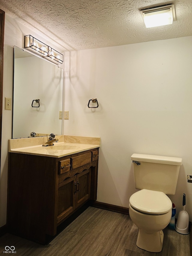 8413 Catamaran Dr, Indianapolis, IN 46236 - bathroom with wood finished floors, vanity, and a textured ceiling