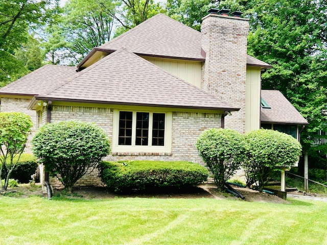 8413 Catamaran Dr, Indianapolis, IN 46236 - view of side of property with a chimney, a shingled roof, and a yard