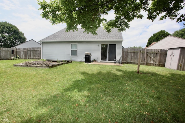 2909 Inverrary Ct, Indianapolis, IN 46234 - back of house with a vegetable garden, a shed, a fenced backyard, a shingled roof, and a patio