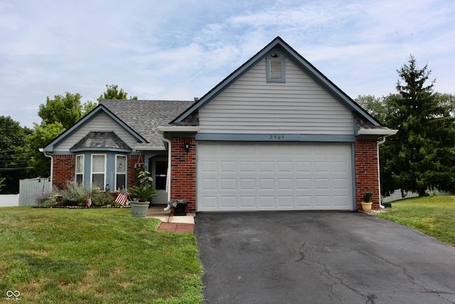 2909 Inverrary Ct, Indianapolis, IN 46234 - view of front facade featuring asphalt driveway, a front lawn, brick siding, and an attached garage