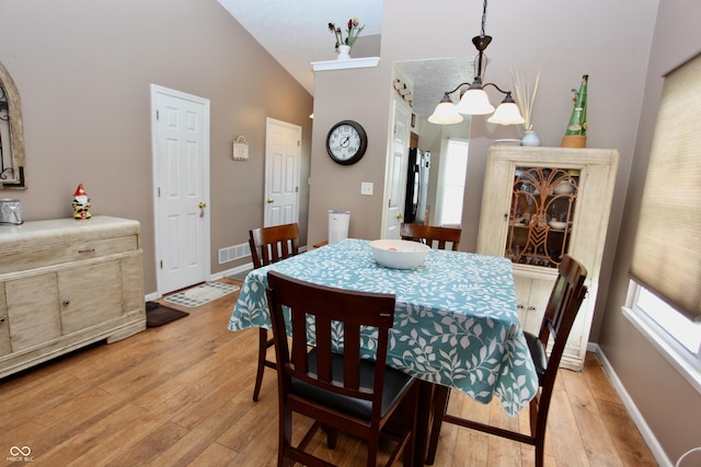 2909 Inverrary Ct, Indianapolis, IN 46234 - dining room with light wood-style floors, vaulted ceiling, and a chandelier