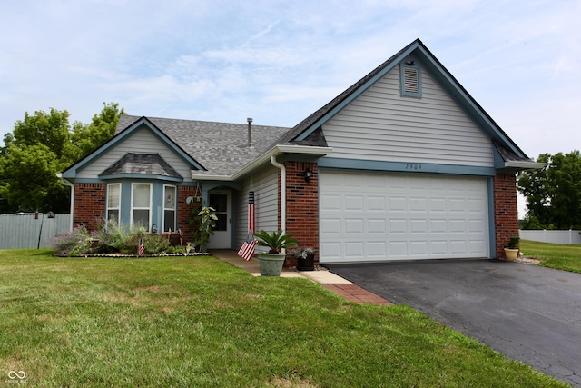 2909 Inverrary Ct, Indianapolis, IN 46234 - view of front of house with brick siding, driveway, an attached garage, and a shingled roof