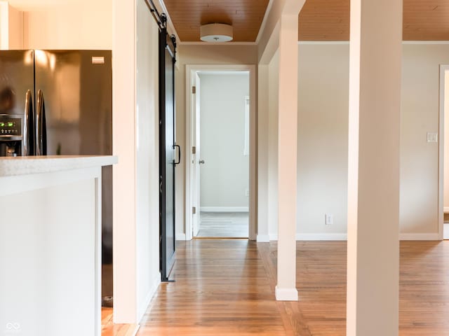 945 E Worthsville Rd, Greenwood, IN 46143 - corridor with light wood-style flooring, a barn door, and crown molding