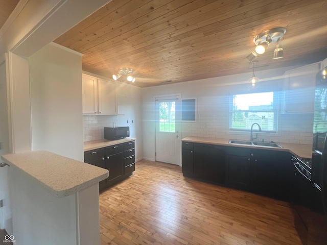 945 E Worthsville Rd, Greenwood, IN 46143 - kitchen featuring black microwave, decorative backsplash, light countertops, wooden ceiling, and dark cabinetry