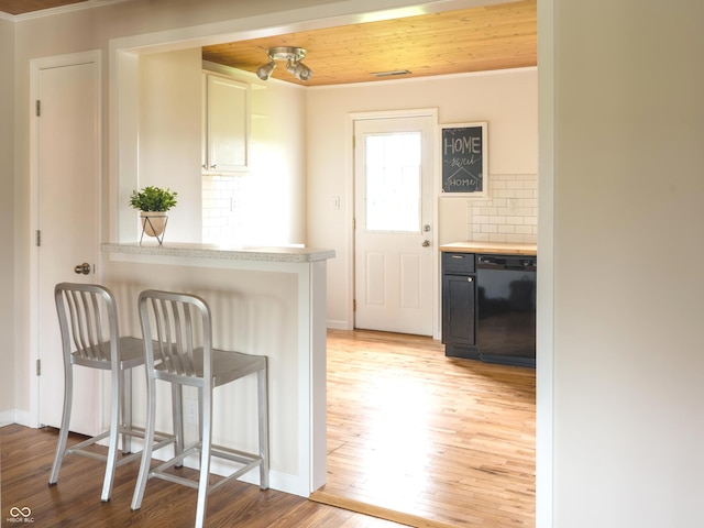 945 E Worthsville Rd, Greenwood, IN 46143 - kitchen with dishwasher, ornamental molding, light countertops, light wood finished floors, and backsplash