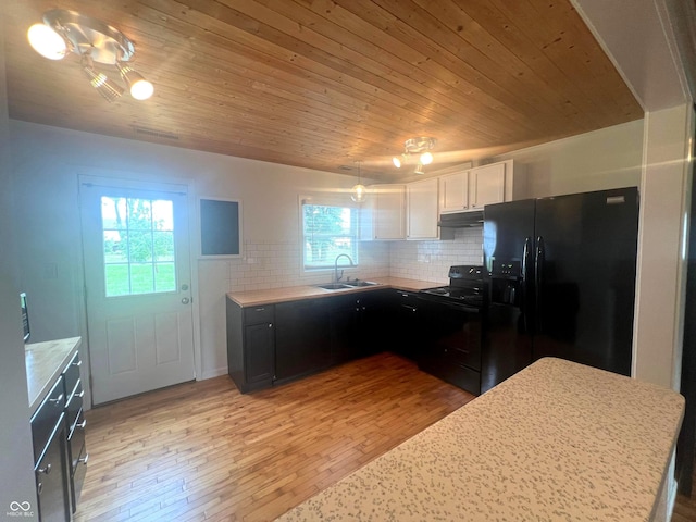 945 E Worthsville Rd, Greenwood, IN 46143 - kitchen featuring black appliances, under cabinet range hood, light countertops, decorative backsplash, and wooden ceiling