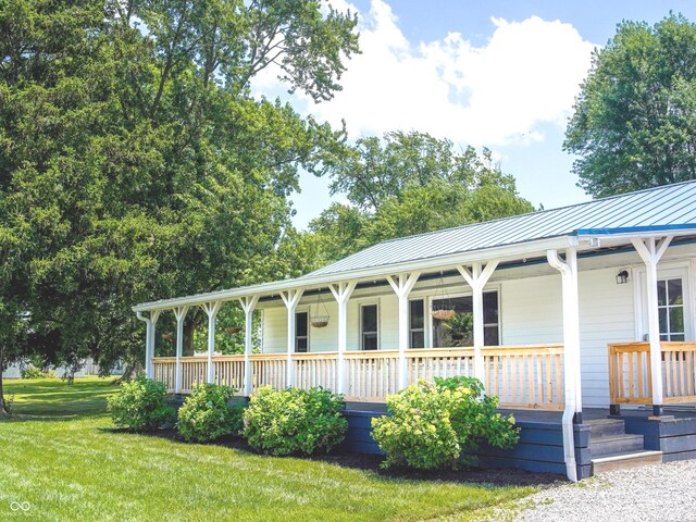 945 E Worthsville Rd, Greenwood, IN 46143 - view of front of property featuring a porch, a metal roof, a front yard, and a standing seam roof
