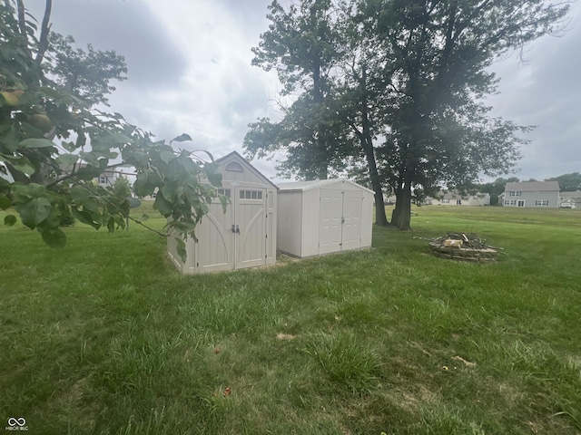 945 E Worthsville Rd, Greenwood, IN 46143 - view of grassy yard featuring a shed and a fire pit