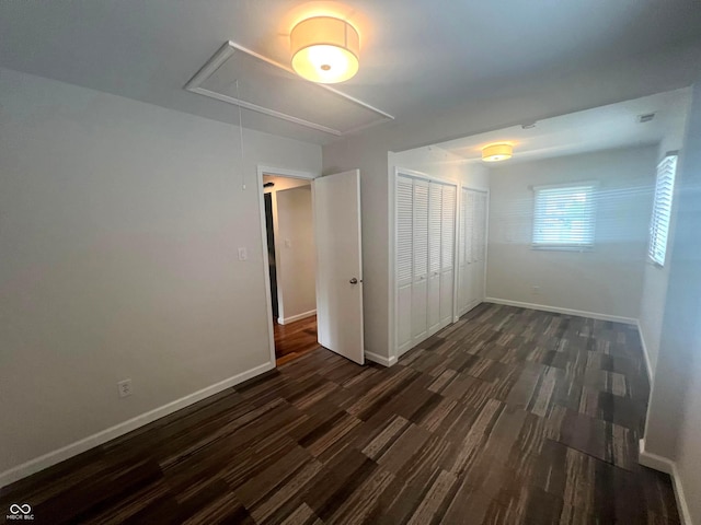 945 E Worthsville Rd, Greenwood, IN 46143 - unfurnished bedroom featuring attic access, a closet, and dark wood-style flooring