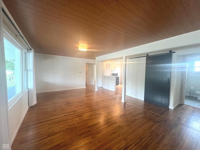 945 E Worthsville Rd, Greenwood, IN 46143 - unfurnished bedroom with wood ceiling, a barn door, and hardwood / wood-style flooring