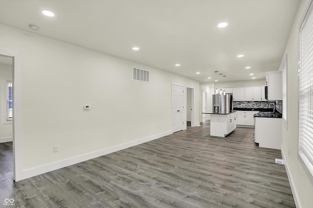 1923 N Parker Ave, Indianapolis, IN 46218 - unfurnished living room with wood finished floors and recessed lighting