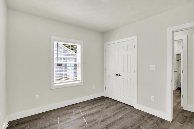 1923 N Parker Ave, Indianapolis, IN 46218 - unfurnished bedroom featuring a closet and wood finished floors