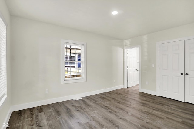 1923 N Parker Ave, Indianapolis, IN 46218 - unfurnished bedroom with dark wood-style flooring, a closet, and recessed lighting