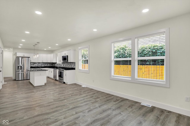 1923 N Parker Ave, Indianapolis, IN 46218 - kitchen featuring stainless steel appliances, recessed lighting, light wood-style floors, backsplash, and white cabinets