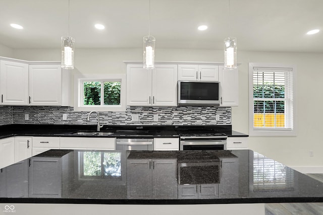 1923 N Parker Ave, Indianapolis, IN 46218 - kitchen with stainless steel appliances, white cabinets, backsplash, recessed lighting, and a center island